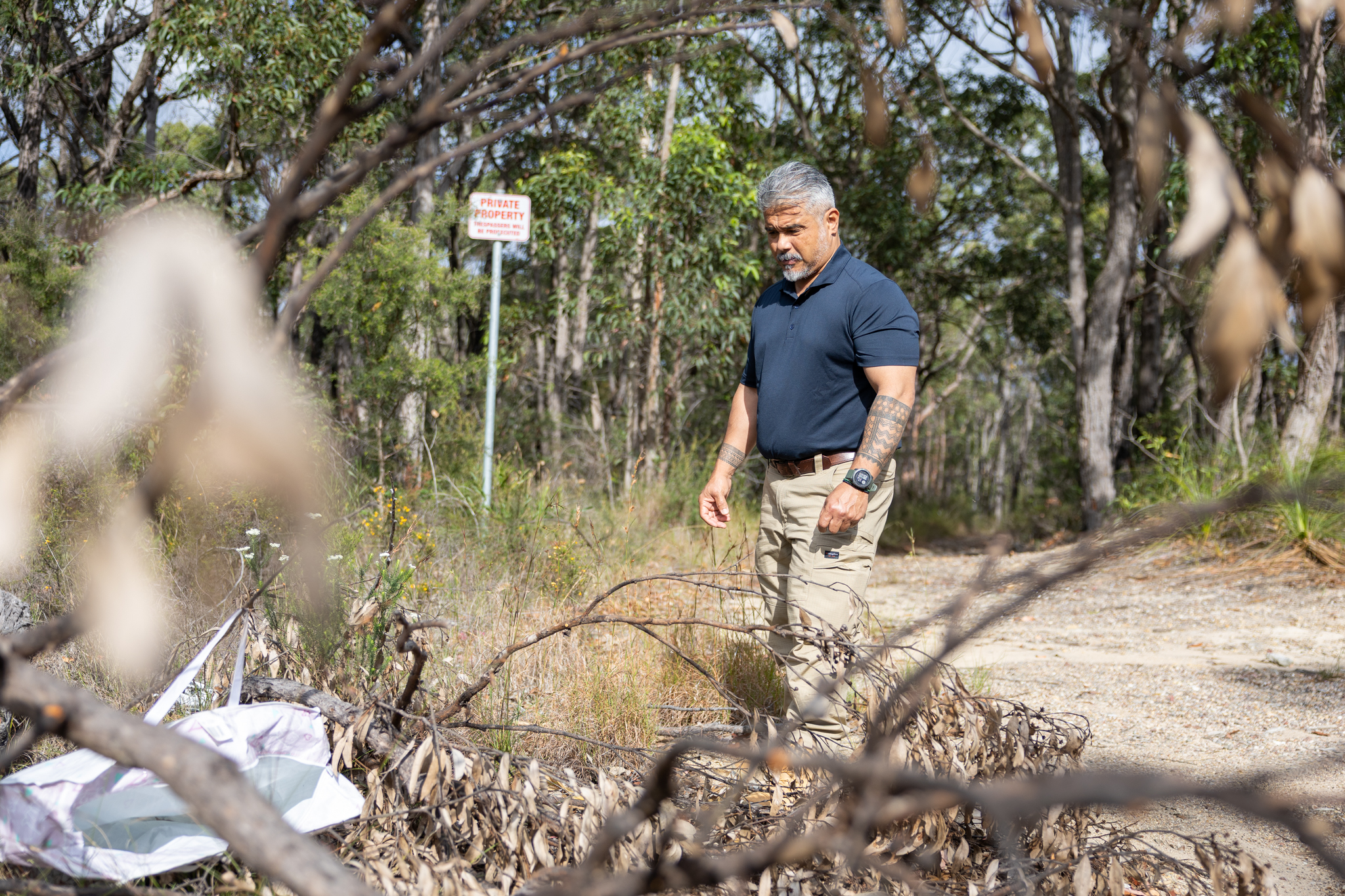 33284_Compliance Officer Angelo Cosgayan inspects a dump site near Wangi Wangi